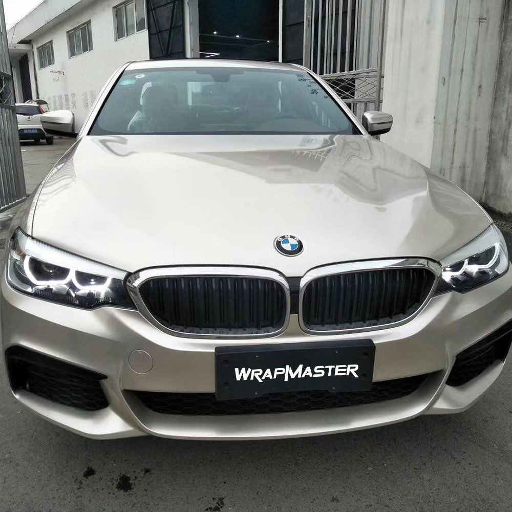 BMW 5 Series front view wrapped in Champagne Light Gold Metallic gloss vinyl, pale warm gold with a soft sheen