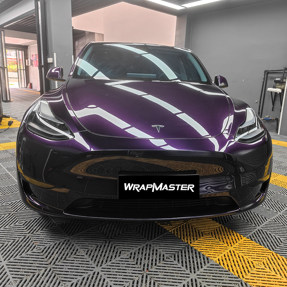 Tesla Model Y wrapped in Metallic Midnight Purple PPF, deep purple gloss hood reflecting shop lights